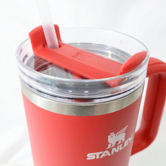 Stanley red tumbler close-up with matching handle and flip straw lid