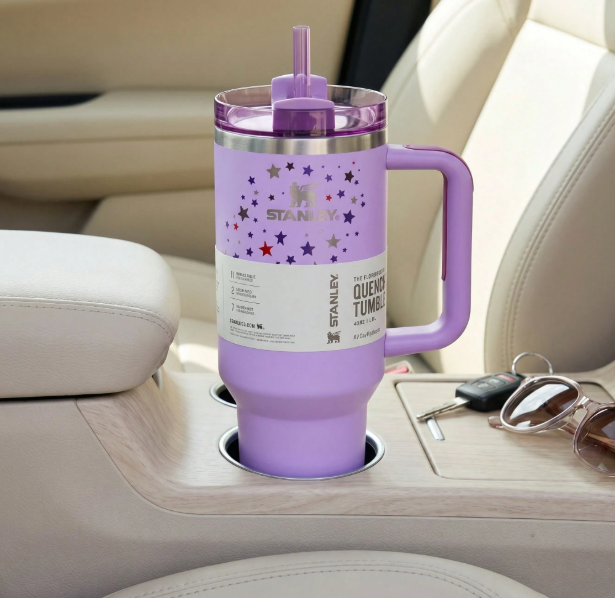 Stanley 40oz purple star pattern tumbler in car cup holder