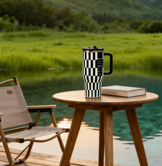 Black and white checkerboard 40oz tumbler outdoors